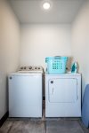 Full size washer and dryer in a laundry room for easy clean up